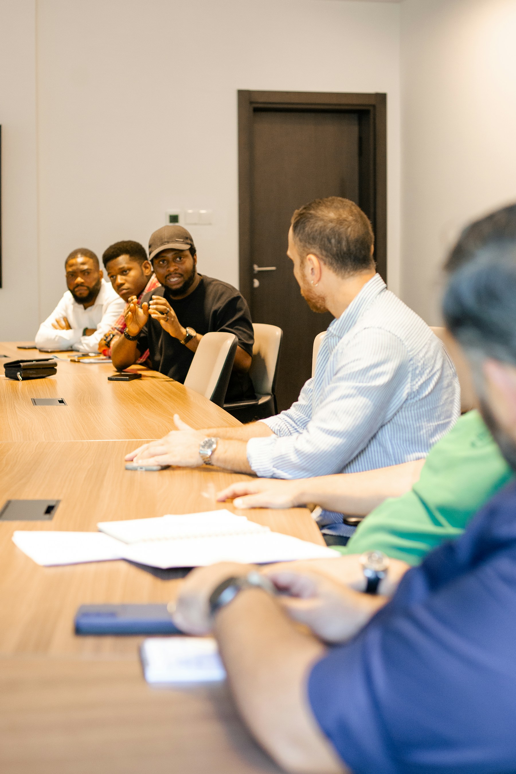 People discussing ideas and leadership around a table
