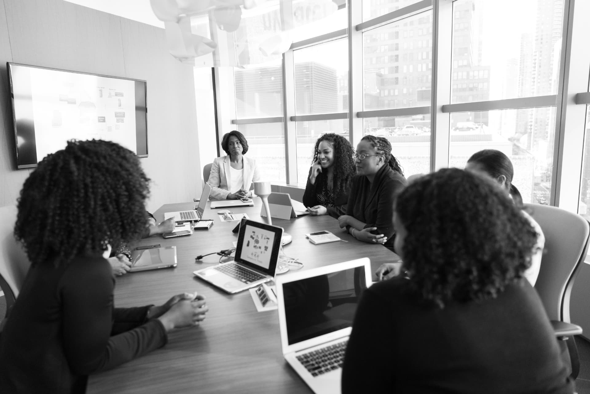 Women collaborating around a boardroom table