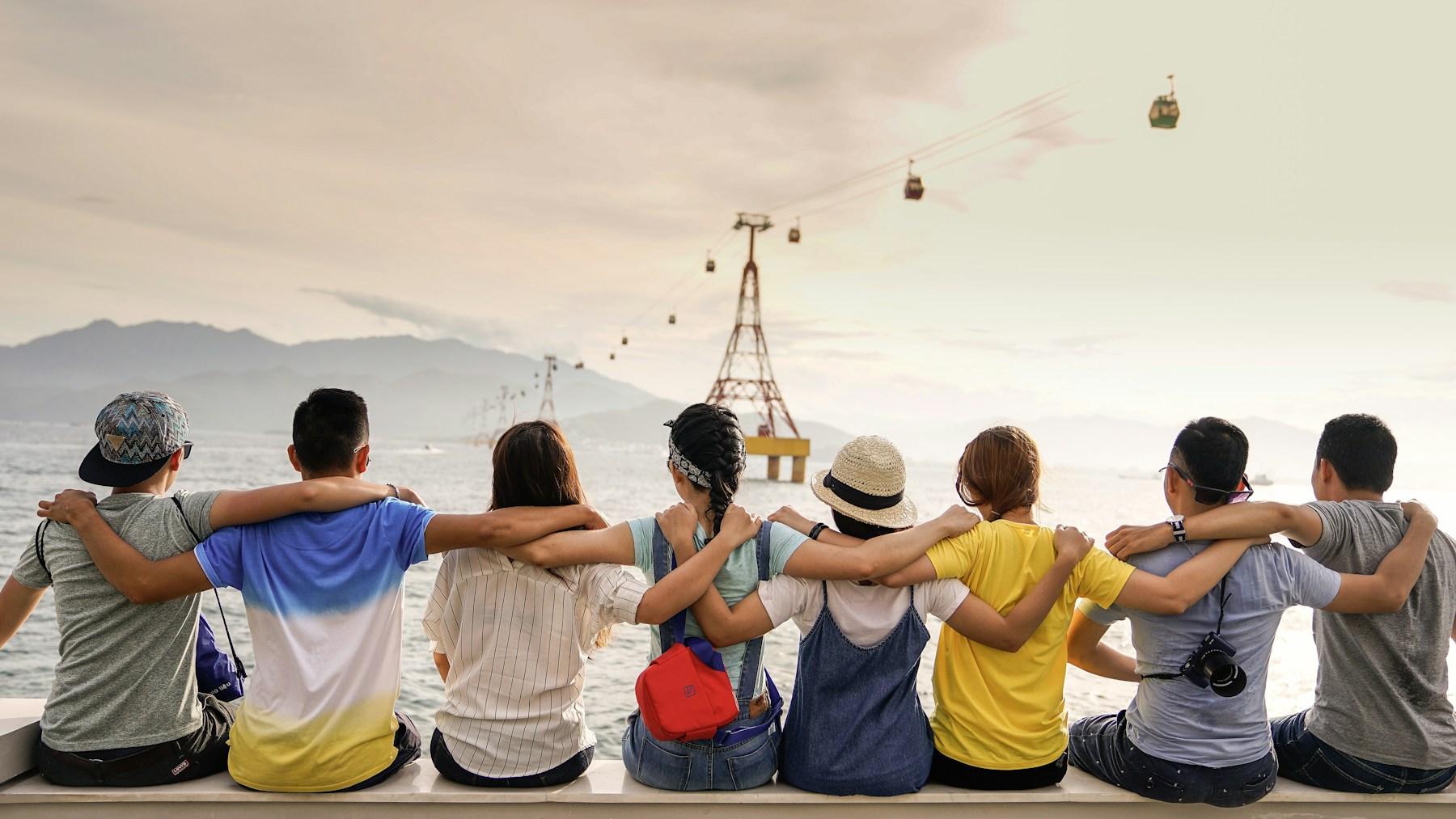 A group of people connecting outdoors beside the water